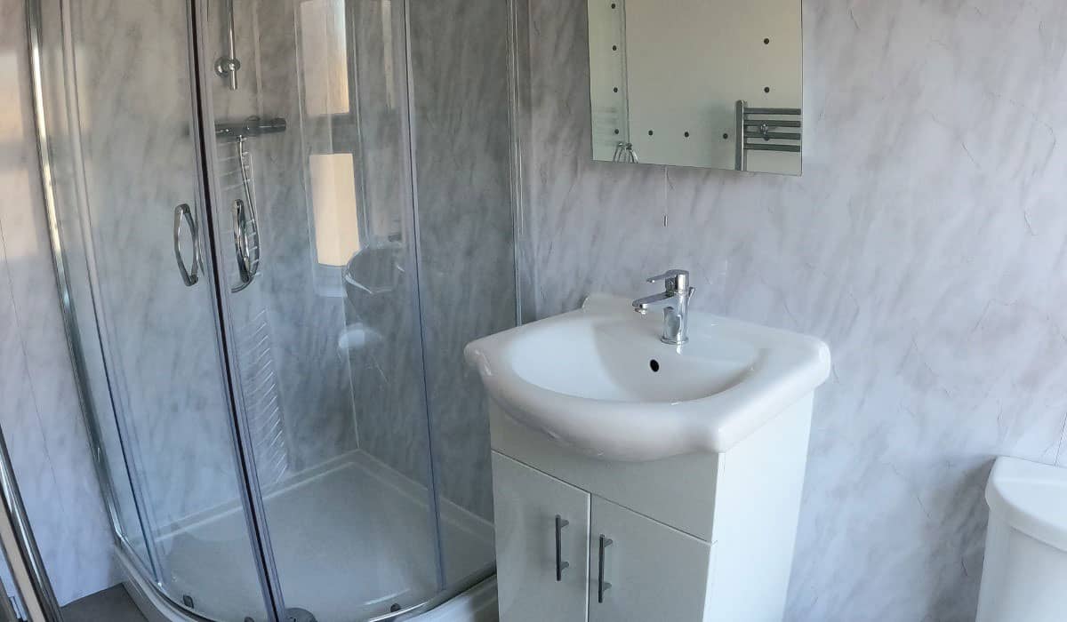 Shower room with vinyl wall tiles in Chester